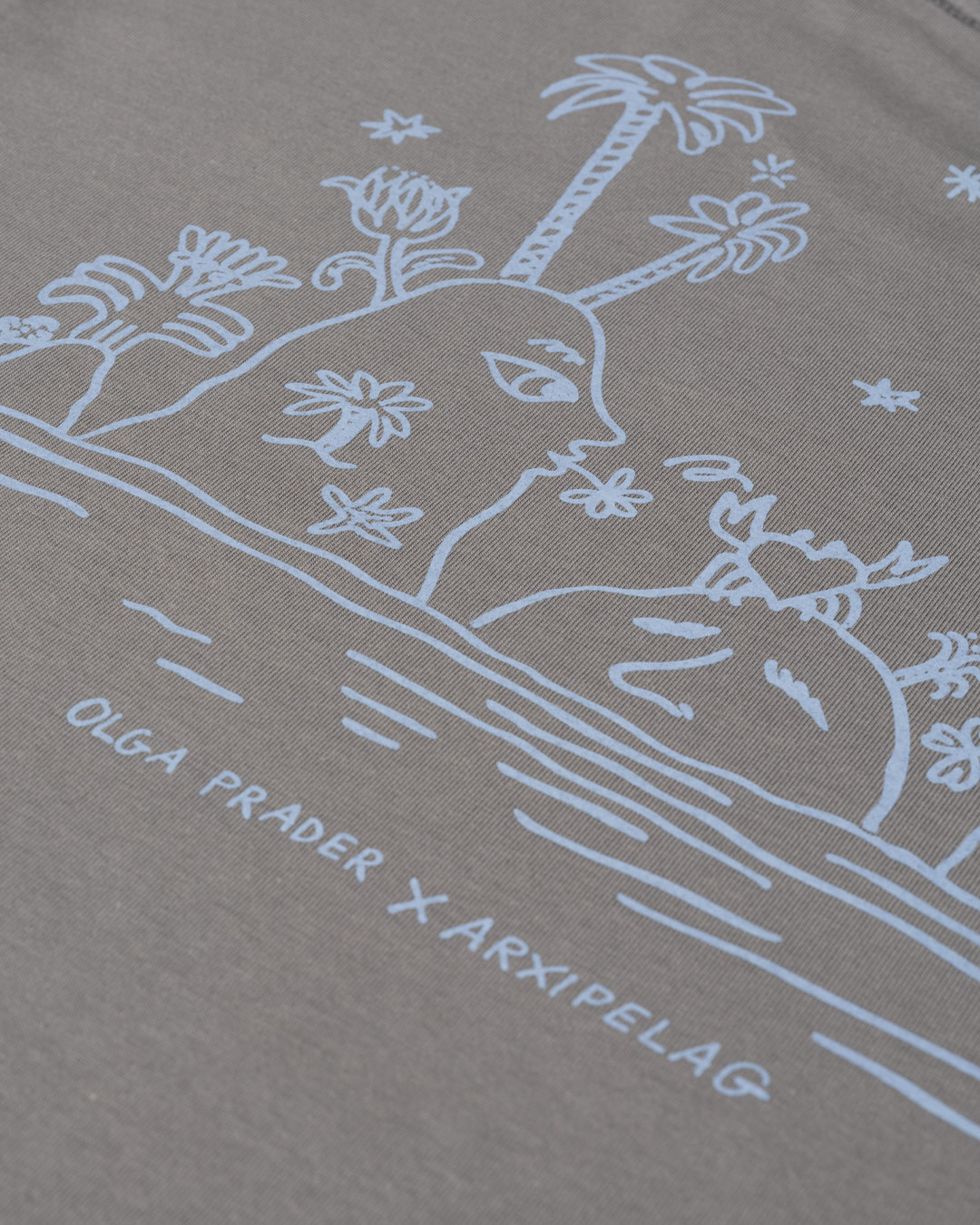 https://arxipelag.com/wp-content/uploads/2026/04/arxipelag-olga-prader-tshirt-islands-detail.jpg